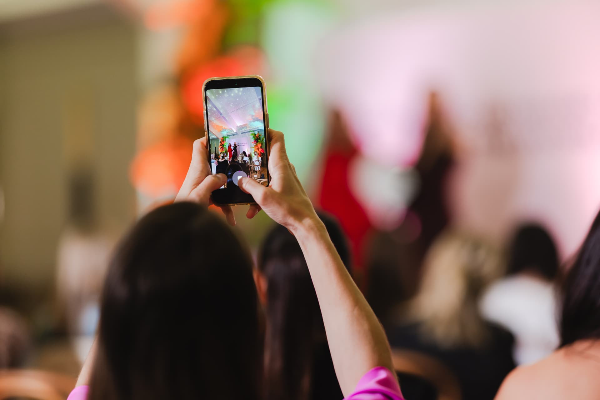 Guests recording the stage from their seats during an Inspired Founders session
