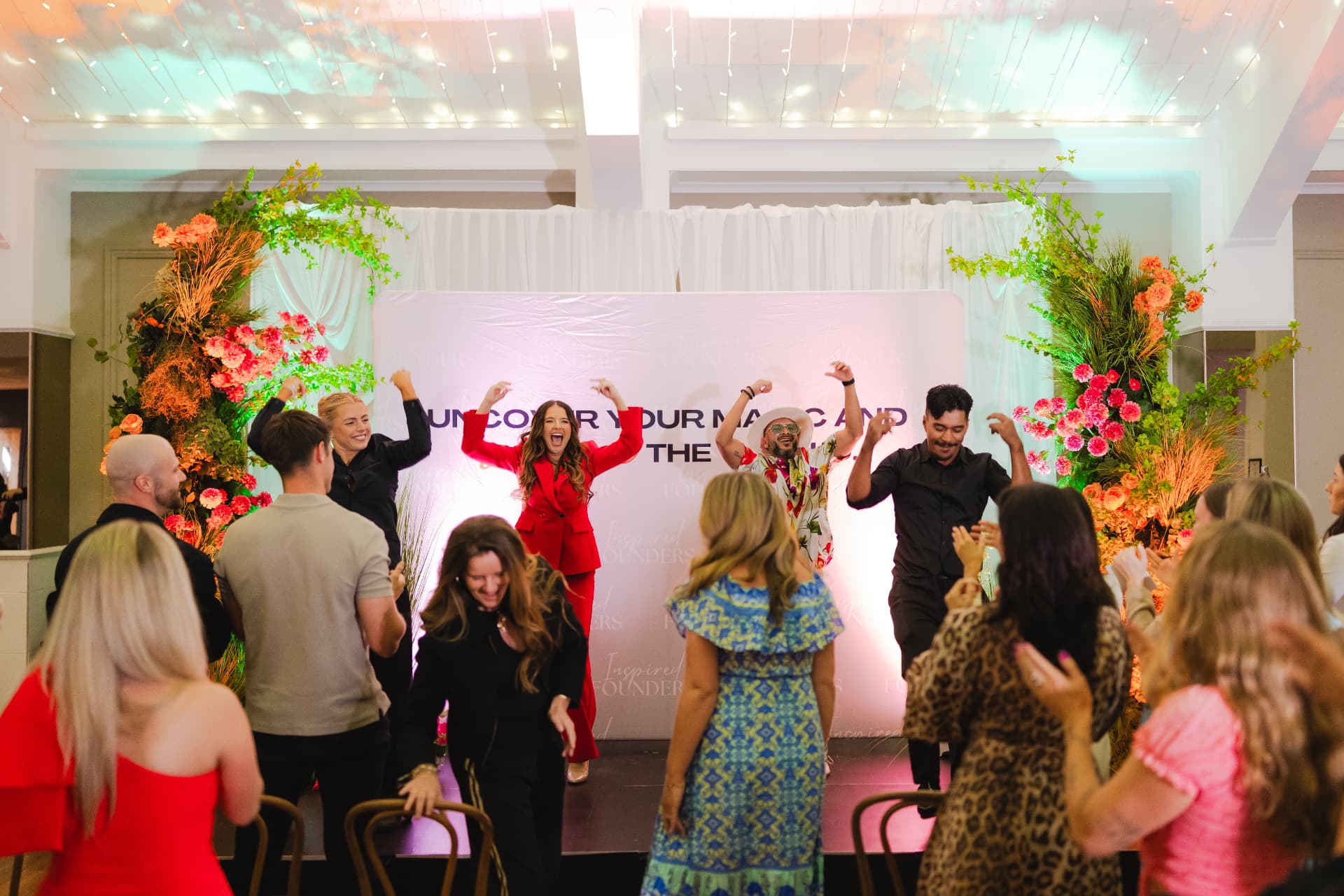 Founders dancing on stage together at the close of an Inspired Founders event